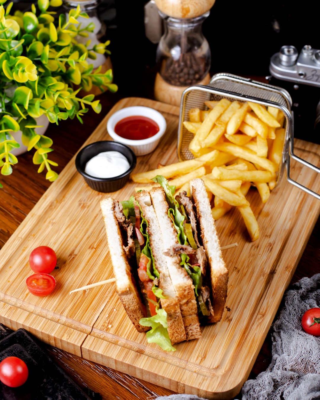 club sandwich with french fries on the table